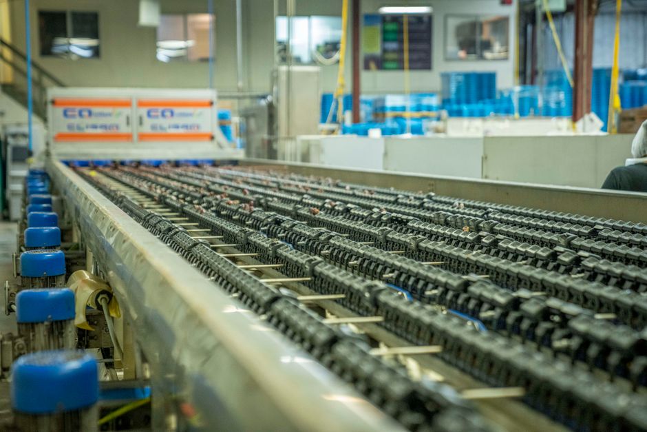 An industrial conveyor belt system running through a manufacturing plant.