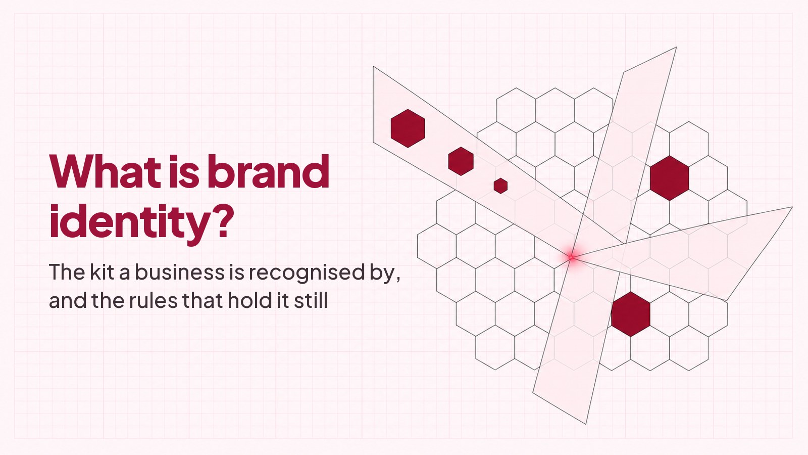 The heading What is brand identity? and the line The kit a business is recognised by, and the rules that hold it still, typeset on faint pink graph paper beside a blueprint drawing of a honeycomb lattice crossed by translucent planes, with one hexagon repeated at three sizes along the upper plane.