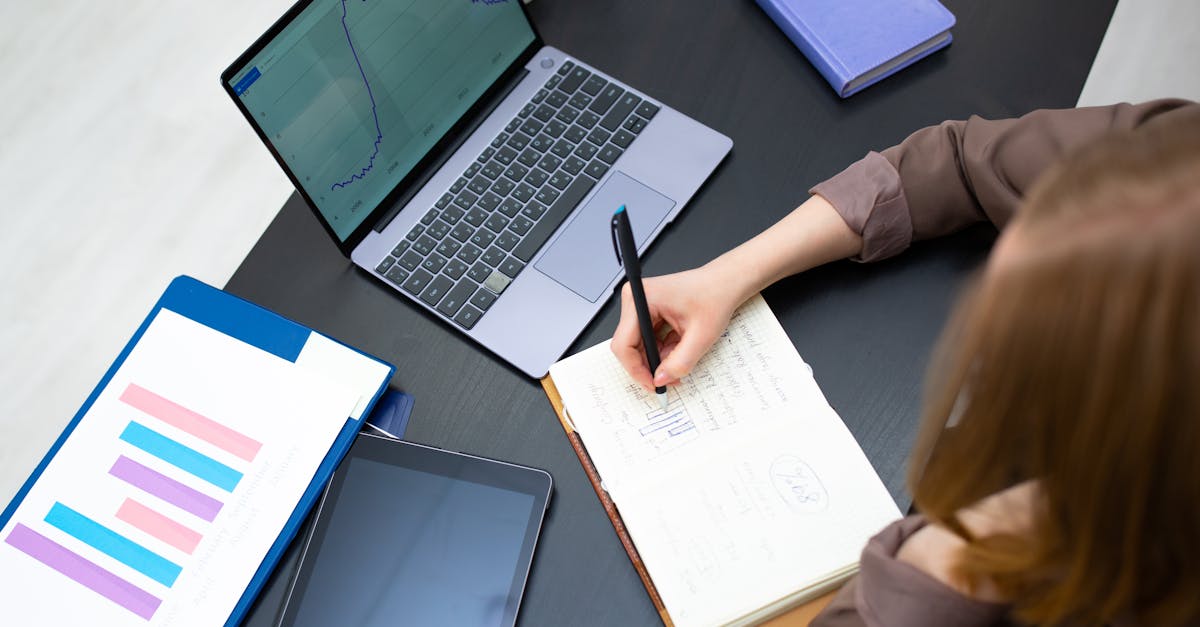 A person carefully evaluating charts and graphs on a computer screen, symbolizing analysis.