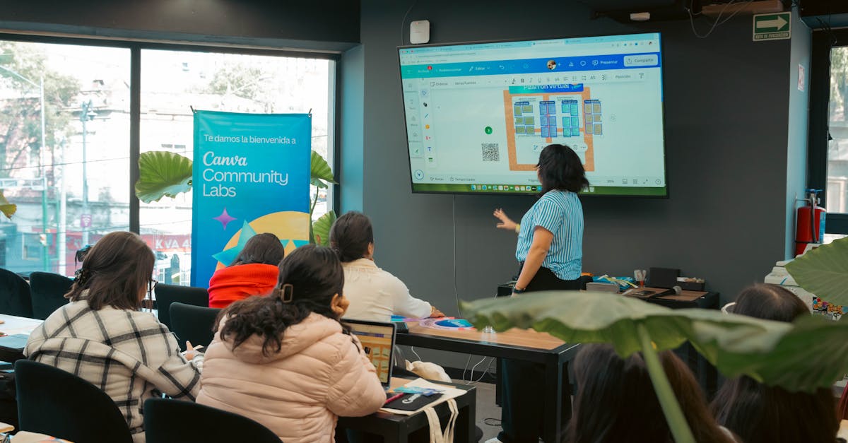 Two professionals leaning over a laptop discussing notes and drafting content for the best seo copywriting course.