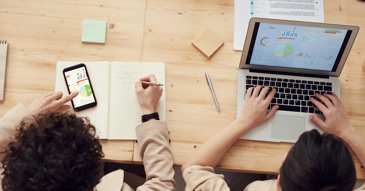 Flat-lay of a workspace showing a laptop, printed blueprint and notes about what is a seo content brief, symbolising content strategy planning.